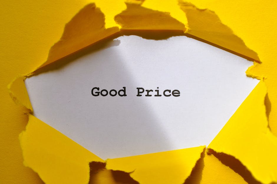 A close-up image shows a piece of bright yellow paper torn in a rough, jagged manner, revealing a white inner layer with the words 'Good Price' printed in black text. The torn edges of the yellow pape